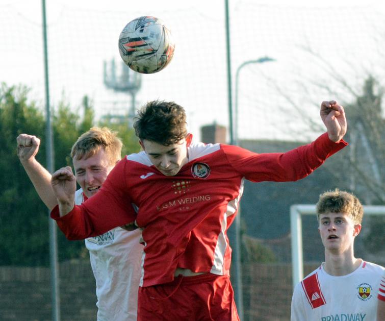 Heads you win - Milford United clearly win this aerial dual at Marble Hall